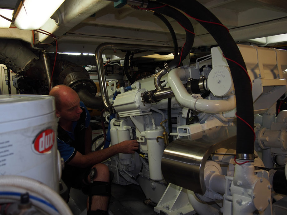 New main engine installed in commercial fishing vessel in Moolloolaba Qld. Engine supplier final checking of install prior to first start.